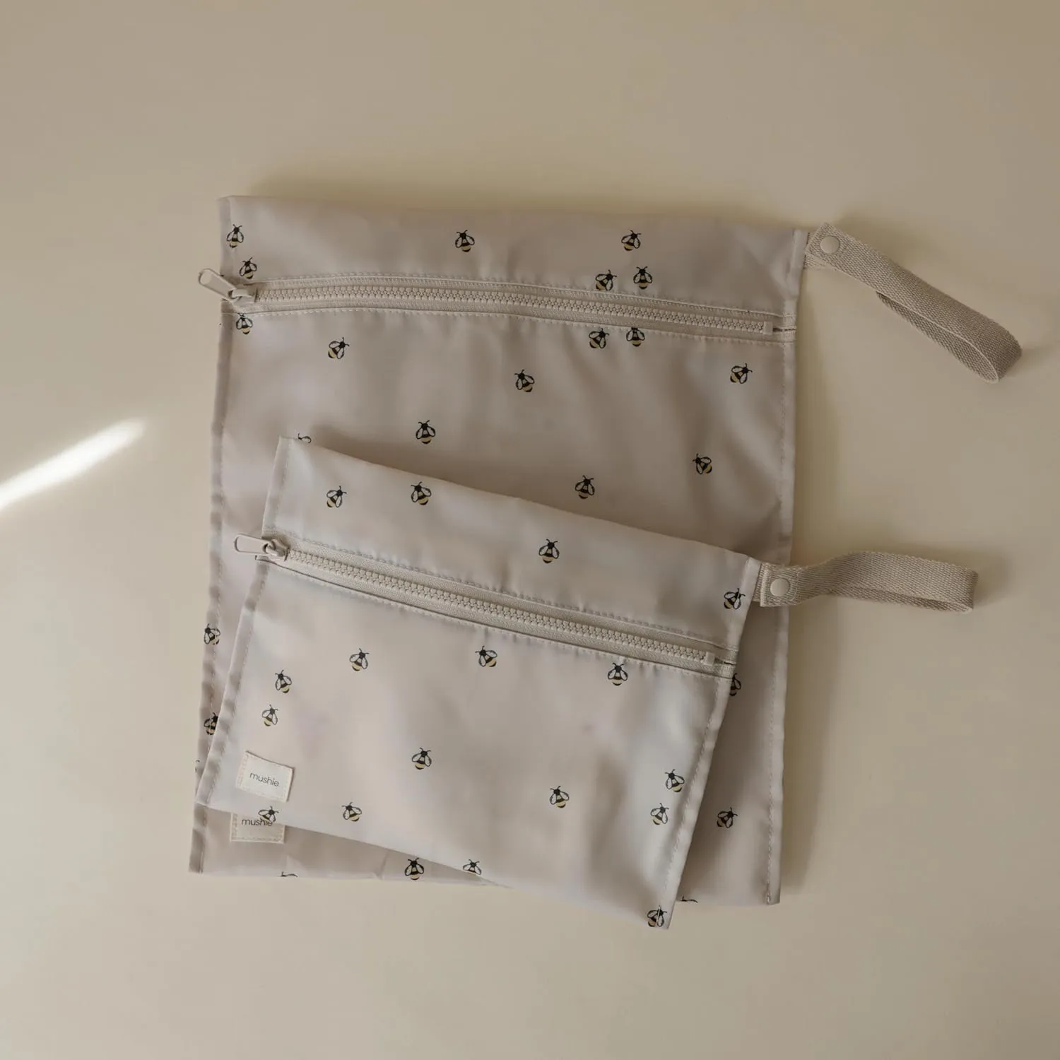 mushie Water Resistant Wet Bags | Large & Small Reusable Storage Bag for Baby Items and Travel | Zippered Pockets with Handle | Machine Washable, Set of 2 (Bees)